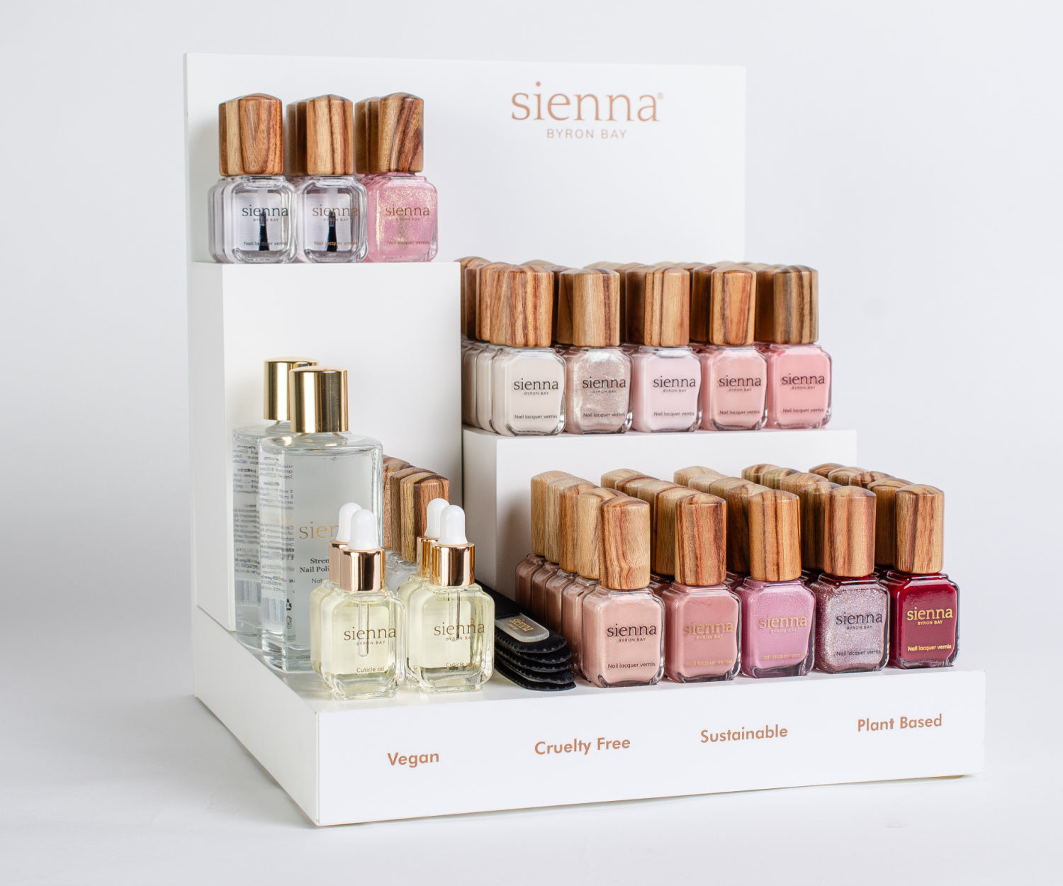 Display of Sienna nail polish bottles with wooden caps on a white background